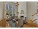 Open living room is bright with tall windows and has a cozy fireplace with a mantel at 2002 Patapsco Dr, Apex, NC 27523