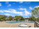 Community swimming pool with lounge chairs and tables, surrounded by mature trees and houses at 2002 Patapsco Dr, Apex, NC 27523
