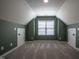Finished attic space with angled ceilings, neutral carpet and paint, and a centered window at 2012 Longmont Dr, Wake Forest, NC 27587