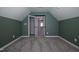 Attic bedroom with vaulted ceilings and a green accent wall at 2012 Longmont Dr, Wake Forest, NC 27587