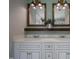 Bathroom featuring shaker cabinets, wood frame mirrors, and stylish lighting at 2012 Longmont Dr, Wake Forest, NC 27587