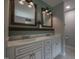 Bathroom with white cabinets, dual sinks, and framed mirrors at 2012 Longmont Dr, Wake Forest, NC 27587
