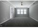 Neutral bedroom with carpet, white trim, and multiple windows allowing for ample light at 2012 Longmont Dr, Wake Forest, NC 27587