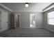 Carpeted bedroom with multiple doorways and windows, allowing for ample light at 2012 Longmont Dr, Wake Forest, NC 27587