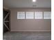 Carpeted bedroom with natural light and a rustic-style sliding barn door at 2012 Longmont Dr, Wake Forest, NC 27587