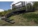 Multi-level deck with stairs surrounded by lush landscaping and wooded area at 2012 Longmont Dr, Wake Forest, NC 27587