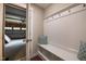 Welcoming entryway with built-in storage bench, coat hooks, and access to the garage at 2012 Longmont Dr, Wake Forest, NC 27587