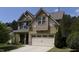 Charming two-story home with a light yellow exterior, complemented by a well-maintained front lawn and attached garage at 2012 Longmont Dr, Wake Forest, NC 27587