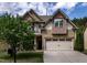 Inviting two-story home with neutral siding, attached garage, and mature tree in the front yard at 2012 Longmont Dr, Wake Forest, NC 27587