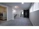 A carpeted hallway with a barn door, laundry room, and access to other rooms at 2012 Longmont Dr, Wake Forest, NC 27587
