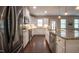 Bright, modern kitchen featuring white cabinets, granite countertops, and stainless steel appliances at 2012 Longmont Dr, Wake Forest, NC 27587