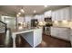 Modern kitchen with white cabinets, stainless steel appliances, and a large center island at 2012 Longmont Dr, Wake Forest, NC 27587