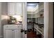 Walk-in pantry with custom white shelving and black countertop provides ample storage space at 2012 Longmont Dr, Wake Forest, NC 27587