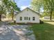 Rear exterior featuring a gravel driveway, small yard and an inviting back entrance at 206 Mansfield Dr, Broadway, NC 27505
