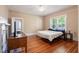 Bedroom with hardwood floors, bed and window and doorway that leads to another room at 206 Mansfield Dr, Broadway, NC 27505