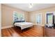 Bright bedroom with hardwood floors, ceiling fan, a bed, and two windows offering natural light at 206 Mansfield Dr, Broadway, NC 27505