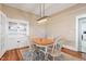 Bright dining room with modern light fixture and built-in cabinets at 206 Mansfield Dr, Broadway, NC 27505