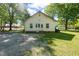 Rear exterior view featuring white siding, a gabled roof, and a gravel driveway at 206 Mansfield Dr, Broadway, NC 27505