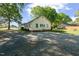 Side rear exterior view featuring white siding, a gabled roof, and a gravel driveway at 206 Mansfield Dr, Broadway, NC 27505