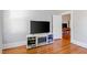 Cozy living room featuring hardwood floors and modern entertainment setup with a doorway to other rooms at 206 Mansfield Dr, Broadway, NC 27505