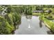 An aerial view of the neighborhood pond with fountains surrounded by wooded areas and houses at 211 Kurtner Ct, Morrisville, NC 27560