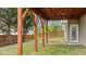 A wooden deck is supported by posts above a grassy backyard with a wood fence at 211 Kurtner Ct, Morrisville, NC 27560