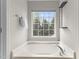 Large tub under a bright window with a shelf and a towel rack at 211 Kurtner Ct, Morrisville, NC 27560