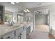 Well-lit bathroom with double vanity, large mirror, and doorway to bedroom and tub at 211 Kurtner Ct, Morrisville, NC 27560