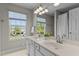 Bright bathroom with double sinks, a large mirror, and natural light at 211 Kurtner Ct, Morrisville, NC 27560