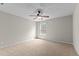 Carpeted bedroom with large windows and a modern ceiling fan at 211 Kurtner Ct, Morrisville, NC 27560