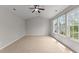 Spacious bedroom with vaulted ceilings, neutral carpet, and three large windows at 211 Kurtner Ct, Morrisville, NC 27560