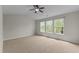 Bright bedroom with large windows, neutral walls and carpeted flooring at 211 Kurtner Ct, Morrisville, NC 27560