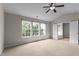Large carpeted bedroom featuring bright natural light and an ensuite bathroom at 211 Kurtner Ct, Morrisville, NC 27560
