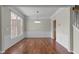Elegant dining room with hardwood floors, large window, chandelier, and staircase views at 211 Kurtner Ct, Morrisville, NC 27560
