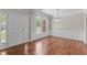 Formal dining room featuring hardwood floors, wainscoting, and an elegant chandelier at 211 Kurtner Ct, Morrisville, NC 27560