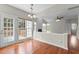 Dining room featuring deck access, an open layout, and hardwood floors at 211 Kurtner Ct, Morrisville, NC 27560