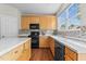 Well-lit kitchen featuring white countertops, mosaic backsplash, and modern appliances at 211 Kurtner Ct, Morrisville, NC 27560