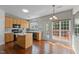 Kitchen area featuring wooden cabinets, a central island, and exterior access to the deck at 211 Kurtner Ct, Morrisville, NC 27560