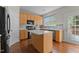 Modern kitchen with light wood cabinets, island, and stainless steel appliances at 211 Kurtner Ct, Morrisville, NC 27560