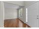 Neutral living room with hardwood floors, large window, and white trim at 211 Kurtner Ct, Morrisville, NC 27560