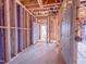 Under construction view of the home's framing, looking through the front door and entry way at 221 Pond View Ct # 9, Fuquay Varina, NC 27526