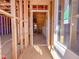 Under construction view of the home's framing, looking from the front door, through the entry way and stair case at 221 Pond View Ct # 9, Fuquay Varina, NC 27526