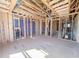 Open-concept interior framing shows the structure and space, ready for customization with exposed beams and utility access at 221 Pond View Ct # 9, Fuquay Varina, NC 27526
