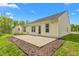 Backyard exterior featuring a concrete patio, a small storage shed, and a well-maintained lawn at 223 Triumph Dr, Elon, NC 27244