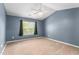 An airy bedroom has carpet flooring, vaulted ceilings, a ceiling fan, and great natural light at 223 Triumph Dr, Elon, NC 27244