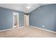 A bright bedroom features a ceiling fan, carpet, and access to an ensuite bathroom at 223 Triumph Dr, Elon, NC 27244