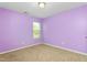 Bedroom with wall-to-wall carpeting, one window, and light purple painted walls at 223 Triumph Dr, Elon, NC 27244