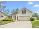 Inviting home with an attached two-car garage, landscaped yard, and covered porch, perfect for a starter home at 223 Triumph Dr, Elon, NC 27244