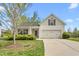 Charming single-Gathering home with a well-maintained lawn, attached two-car garage, and a lovely front porch at 223 Triumph Dr, Elon, NC 27244