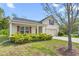 Welcoming single-story home featuring a spacious driveway, manicured landscaping, and charming architectural details at 223 Triumph Dr, Elon, NC 27244